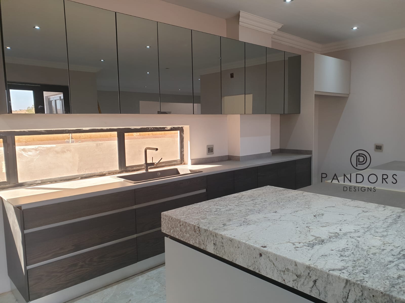 Close-up of a natural stone waterfall countertop finish used in Pandors Designs kitchens