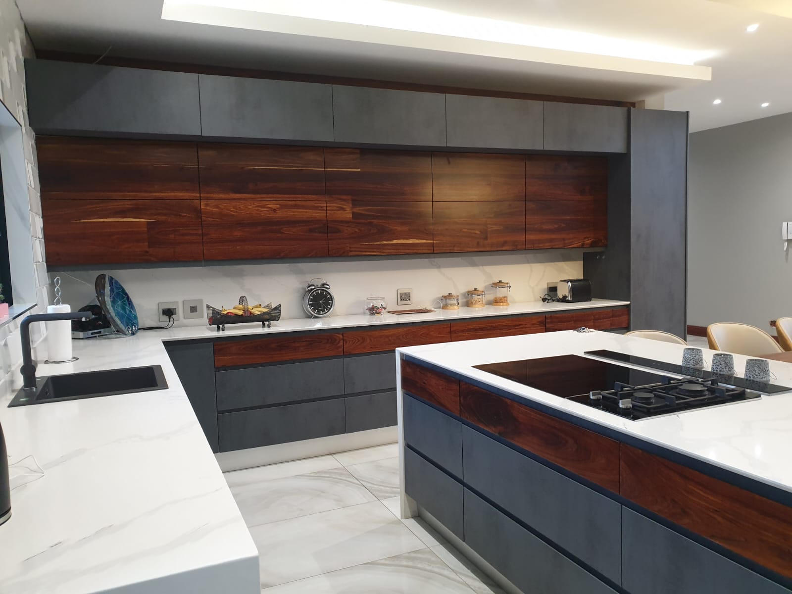 Custom Pandors Designs kitchen in slate grey cabinetry with rosewood-finish accents