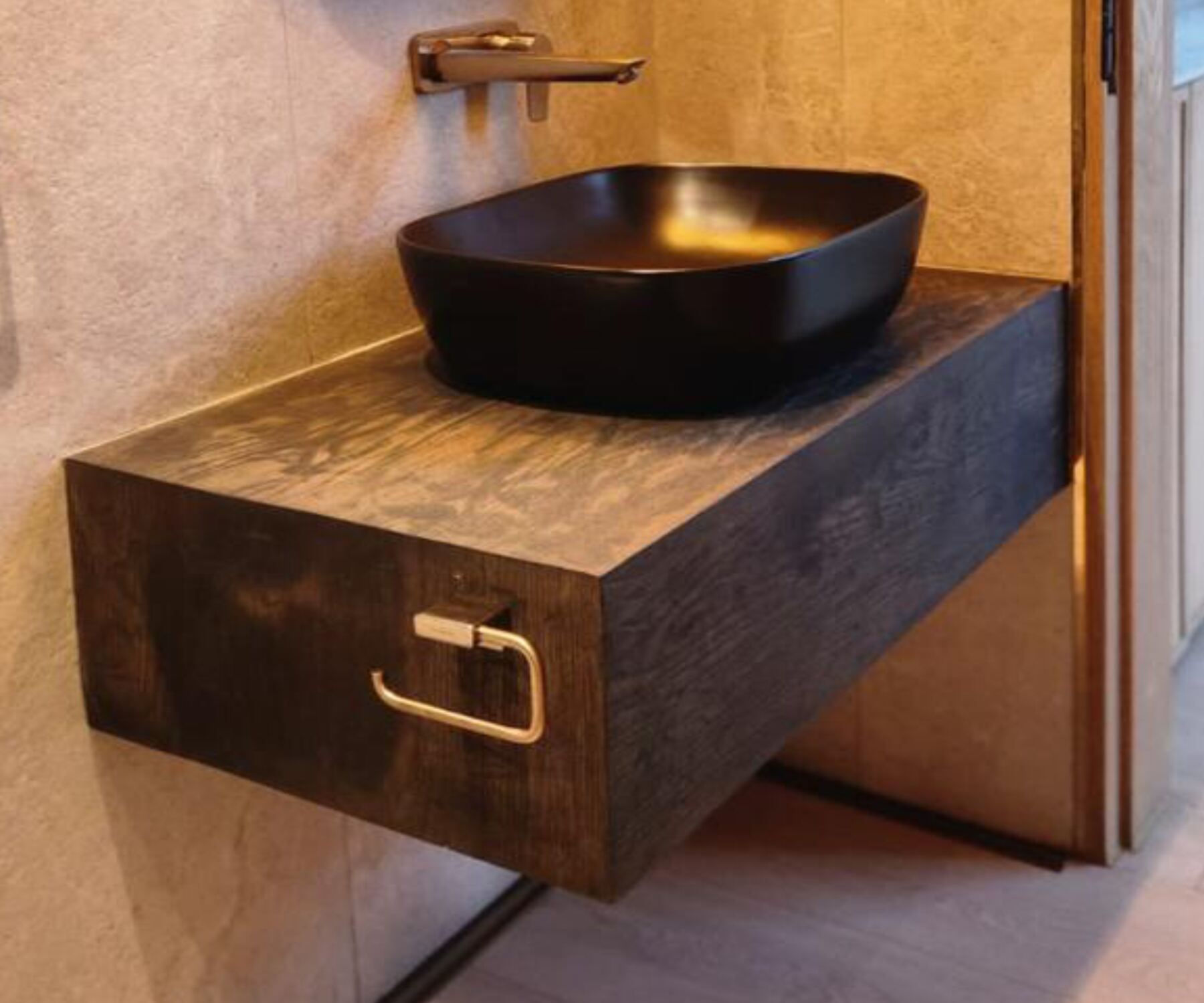 Floating Pandors Designs vanity in dark wood-finish cabinetry with a matte black vessel basin and brass tap