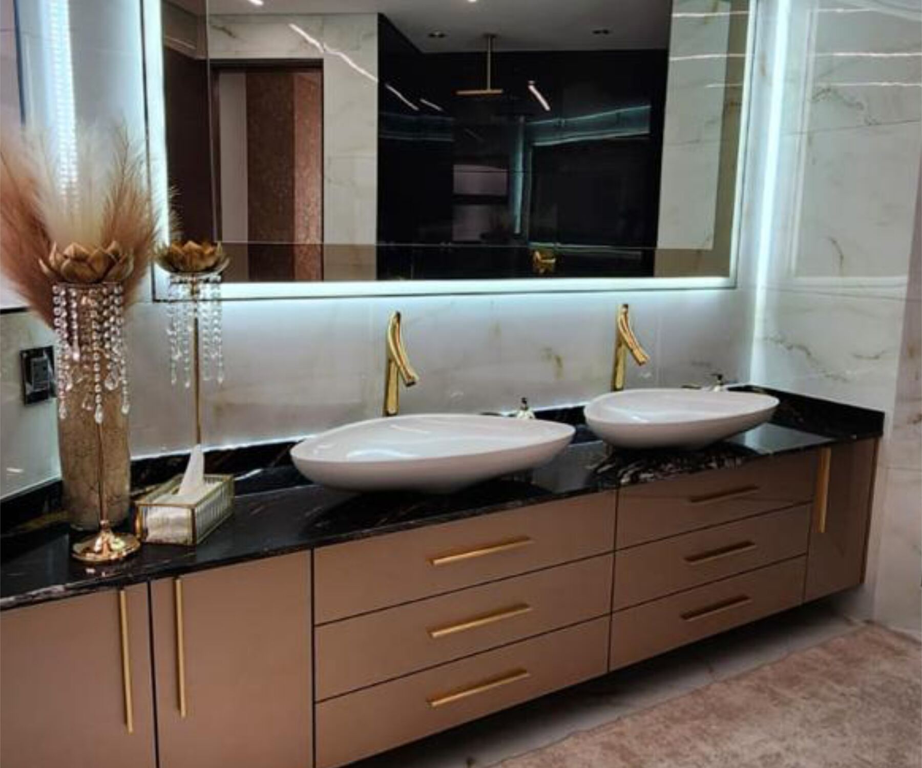 Precision-fitted Pandors Designs bathroom vanity in black stone and rose-gold-finish cabinetry