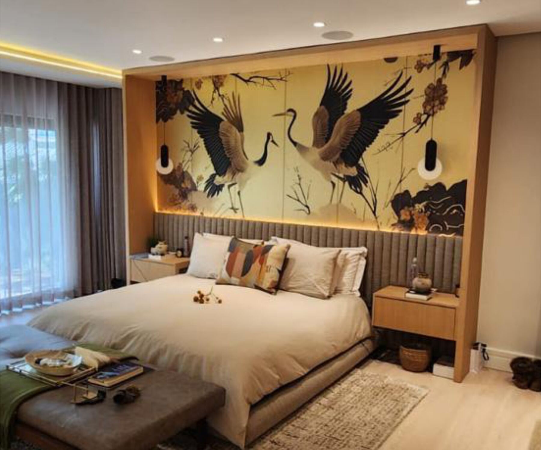 Pandors Designs bedroom with a feature crane-print headboard wall in warm oak and upholstered panelling